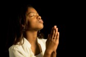 woman praying with folded hands